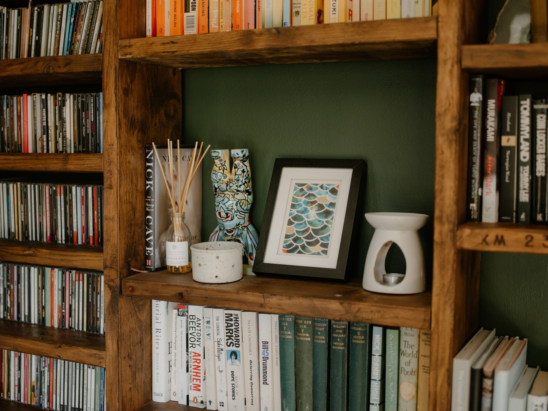 Wooden bookshelf filled with books and decorative items.