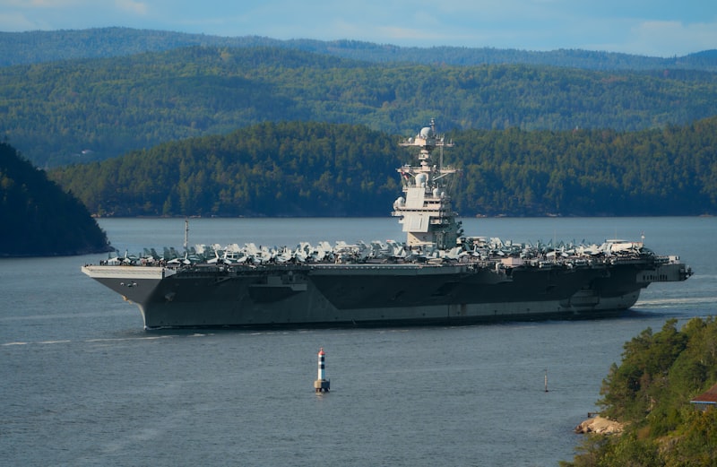 Aircraft carrier sailing on a calm body of water