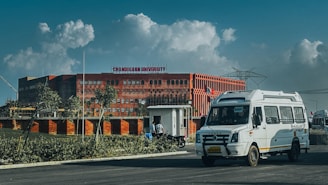 Modern building with a white van in front.