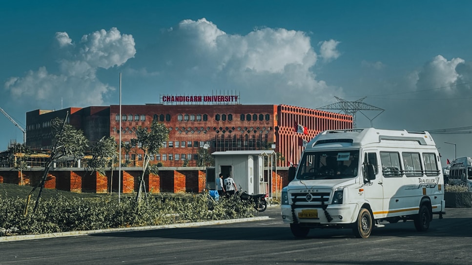 Modern building with a white van in front.