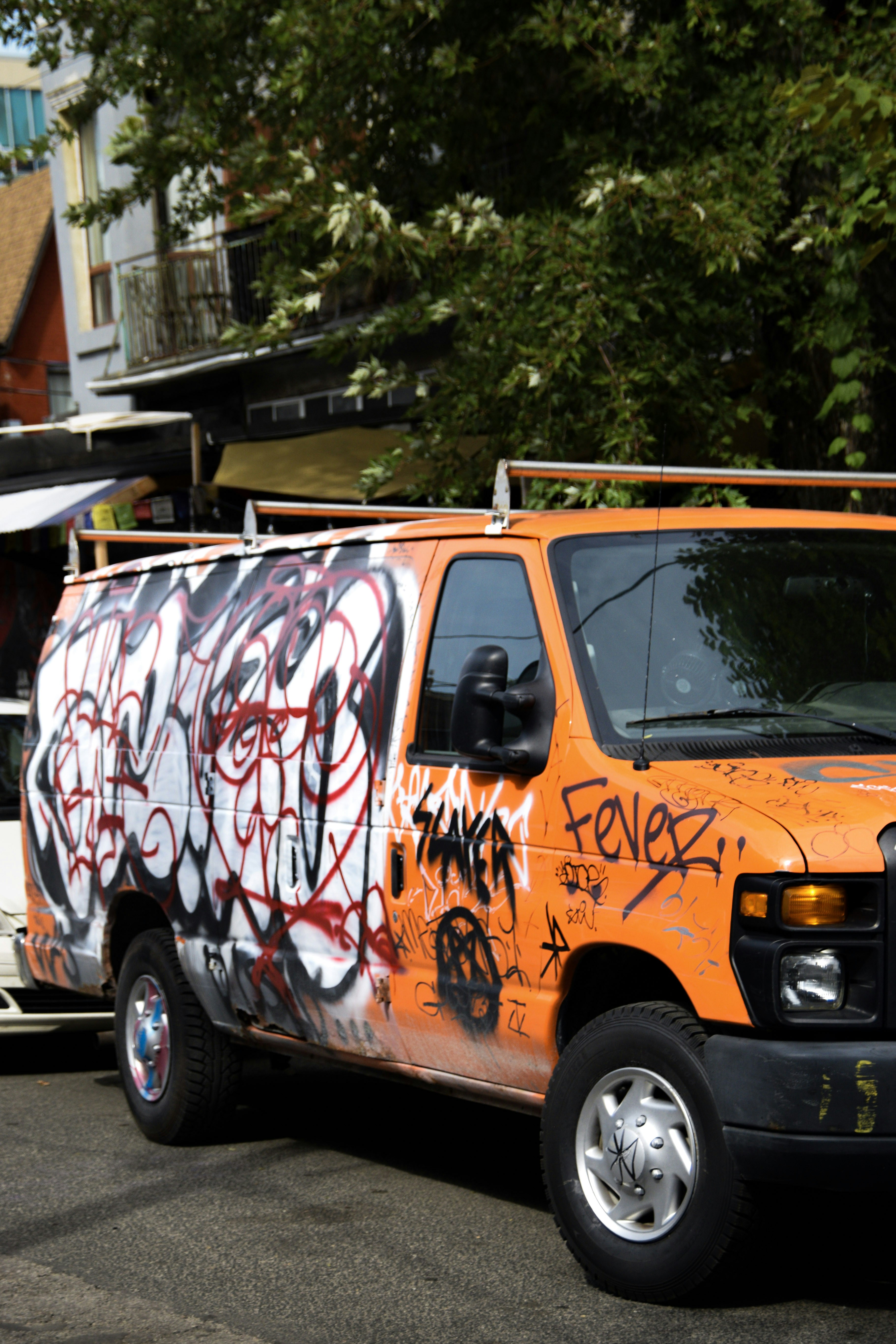 Orange van covered in graffiti art