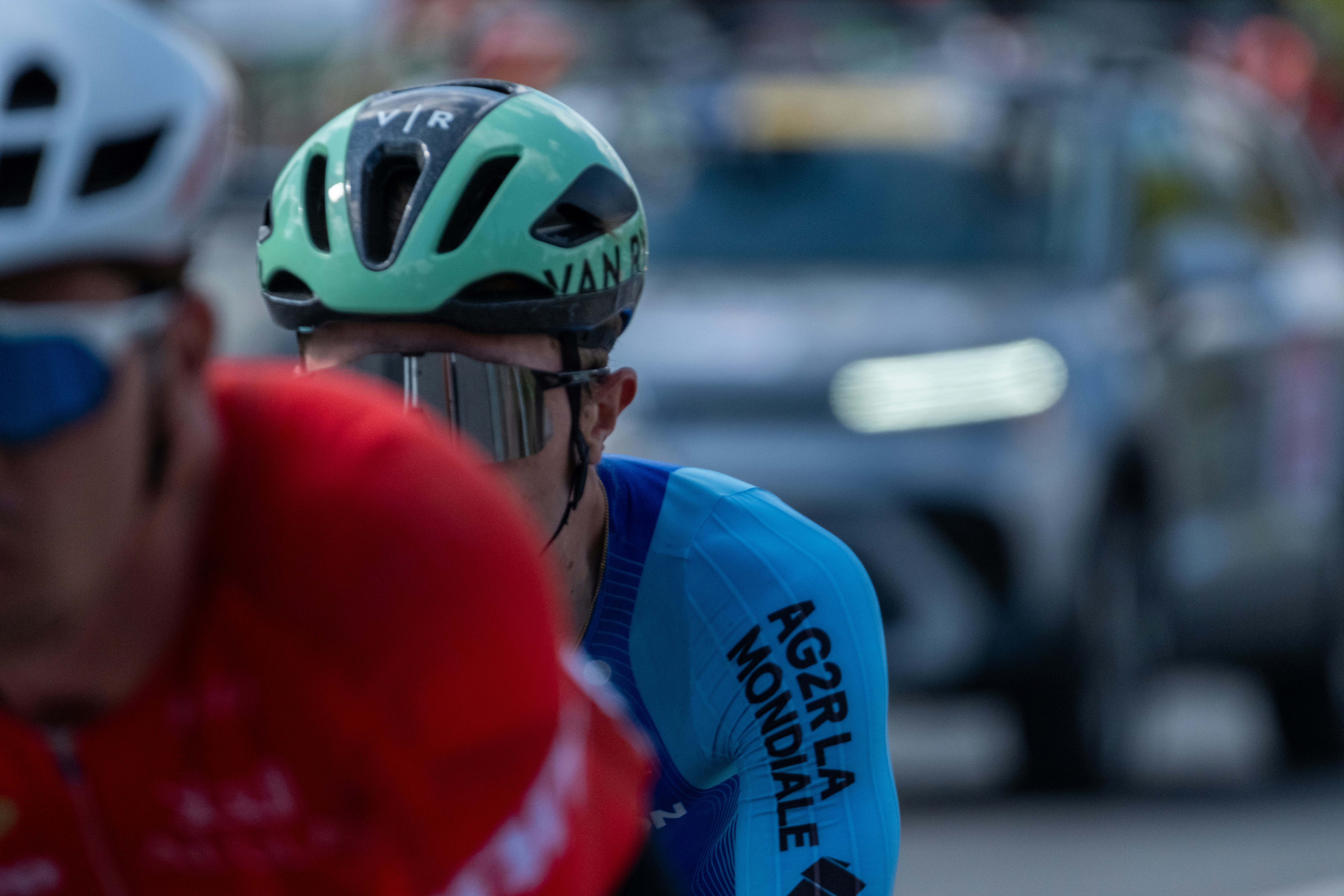 Cyclists wearing helmets and racing gear during competition