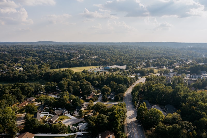 Aerial view of a suburban neighbourhood surrounded by green trees