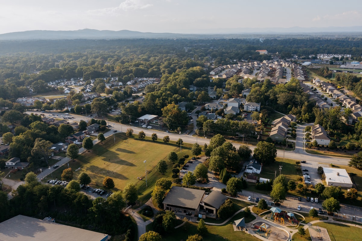 Aerial view of suburban neighborhood with green trees