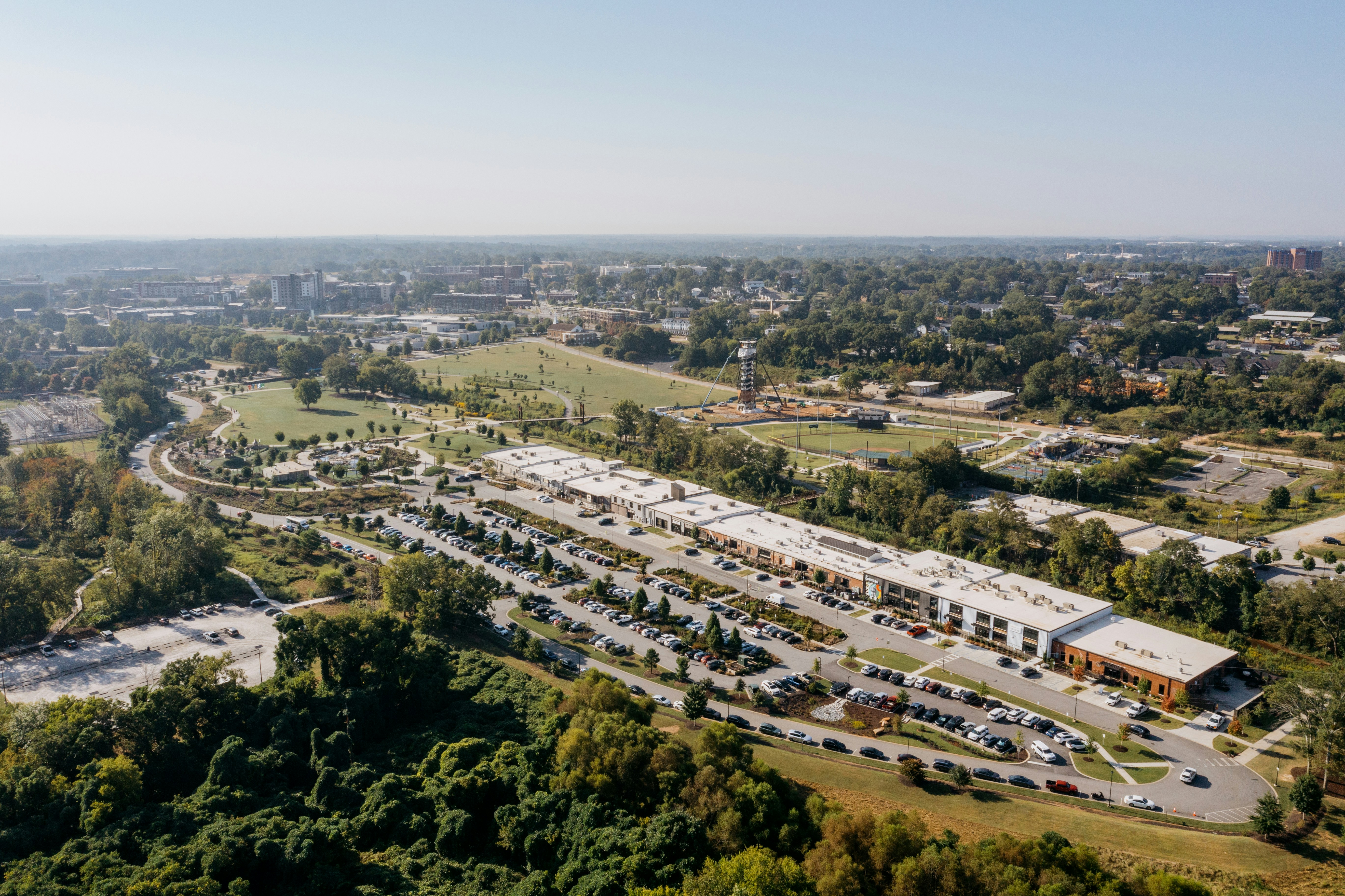 Aerial view of a modern commercial complex with parking lots.