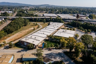 Aerial view of industrial buildings and surrounding landscape.