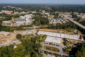 Aerial view of industrial buildings and residential complex.