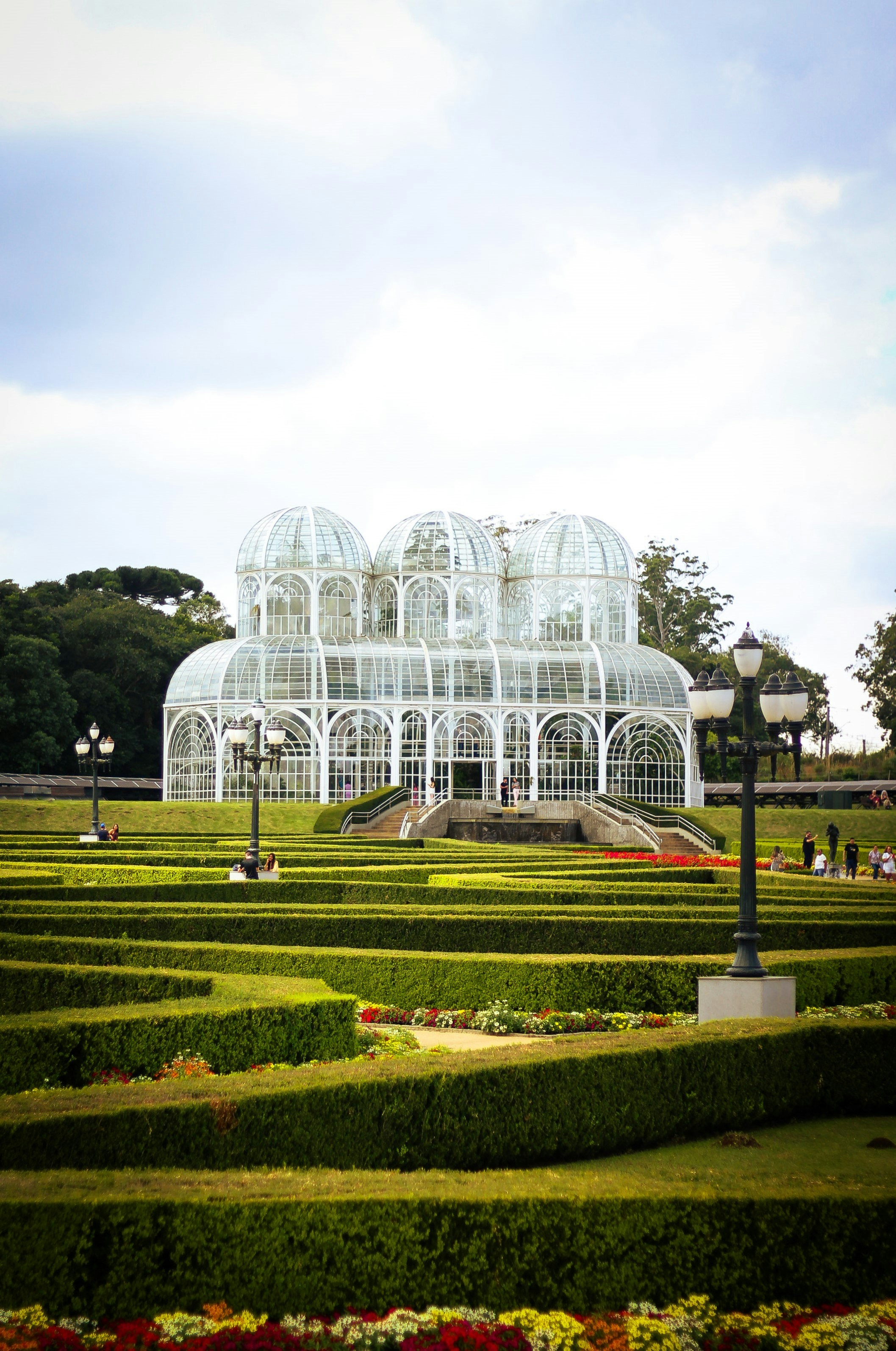 Ornate greenhouse surrounded by manicured gardens