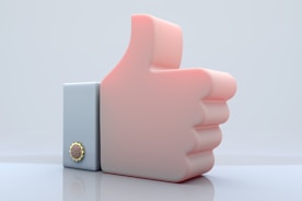 A pink thumb up symbol on a white background.