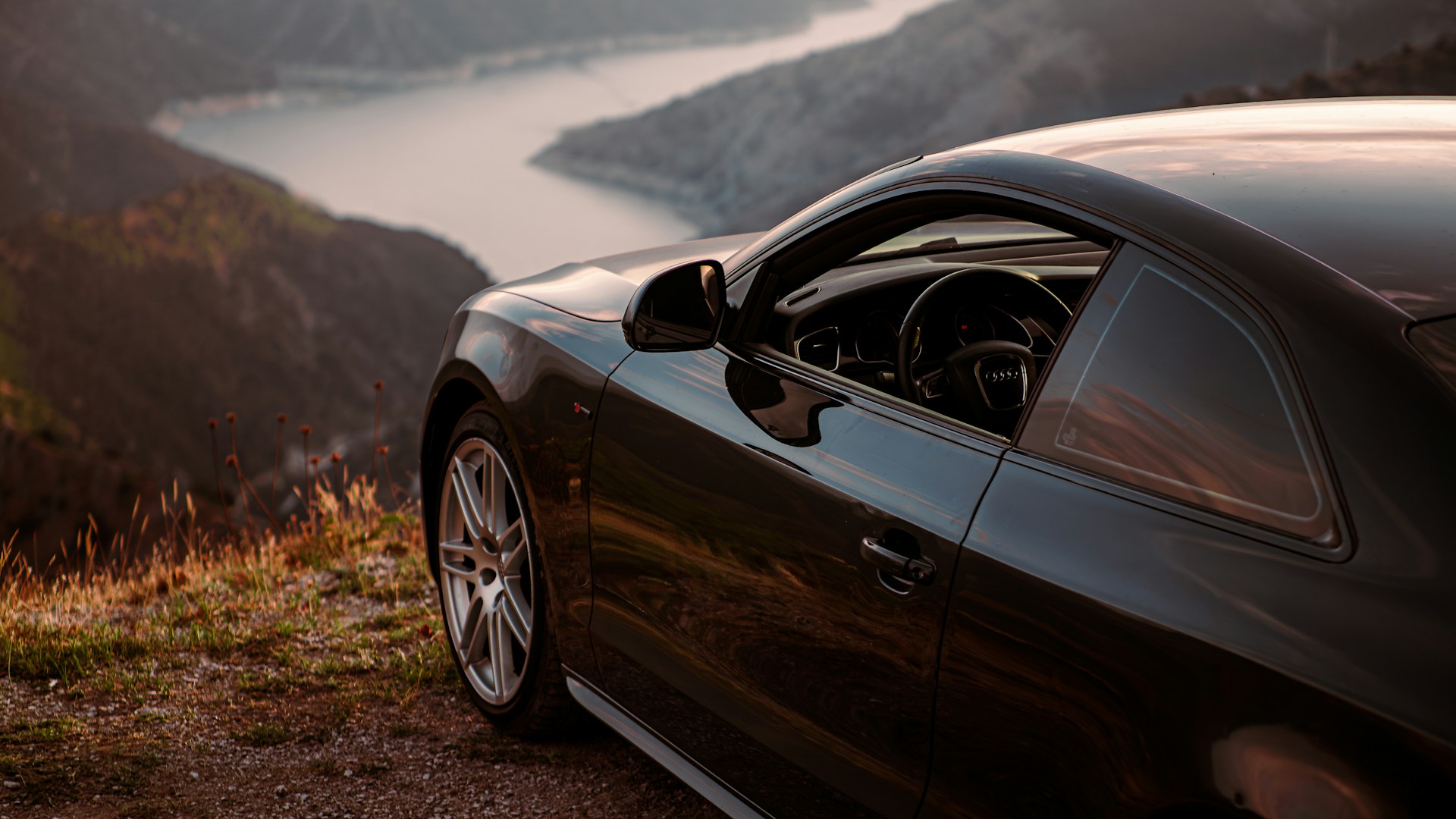 Black car parked on a scenic mountain overlook