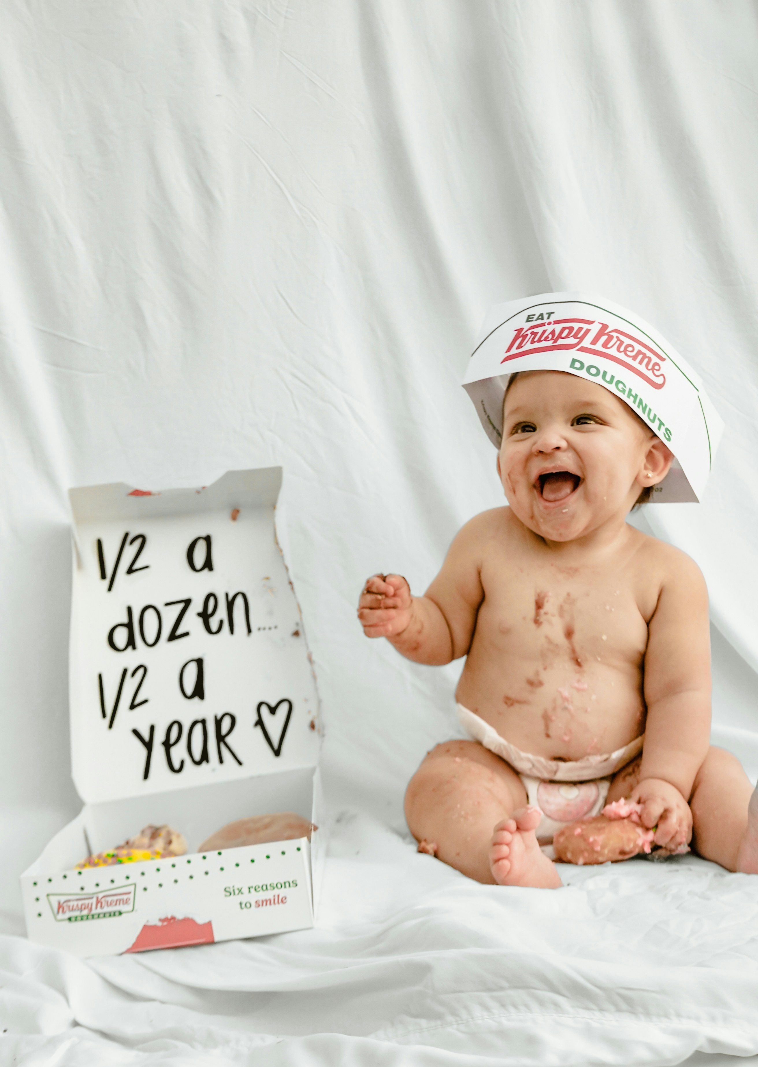 Happy baby with donut hat and box