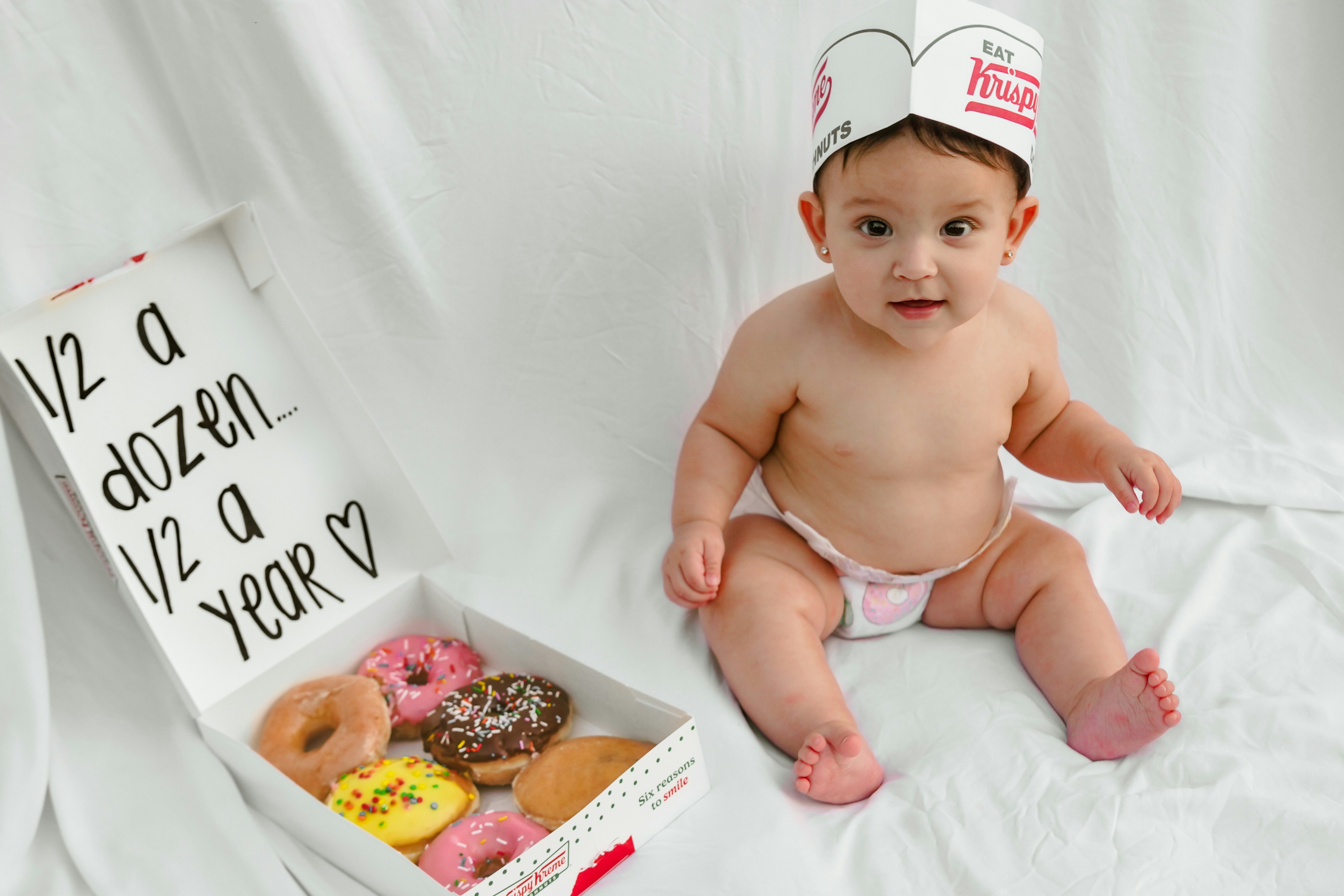Baby with donuts celebrates half a year.
