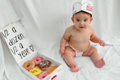 Baby with donuts celebrates half a year.