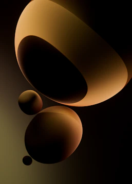 Abstract spheres with warm lighting and dark background.