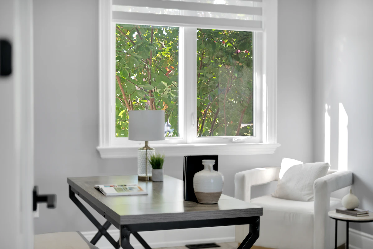 Bright home office with desk, chair, and window.