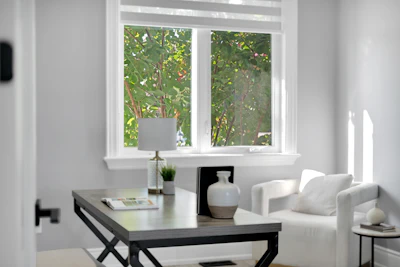 Bright home office with desk, chair, and window.