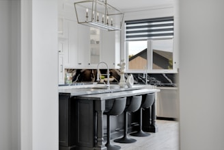 Modern kitchen island with bar stools and marble countertop
