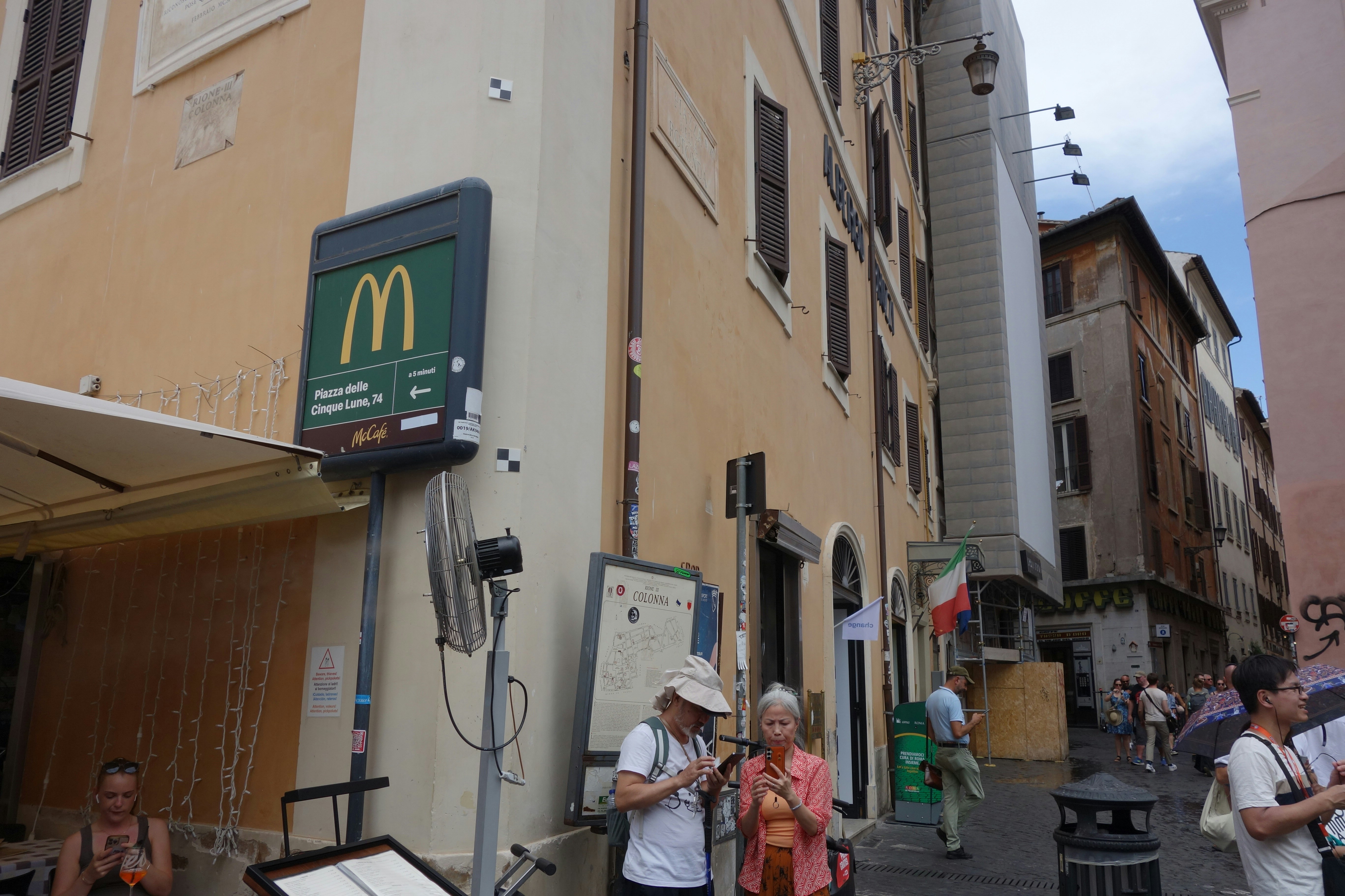 Mcdonald's sign on a building in a city street.