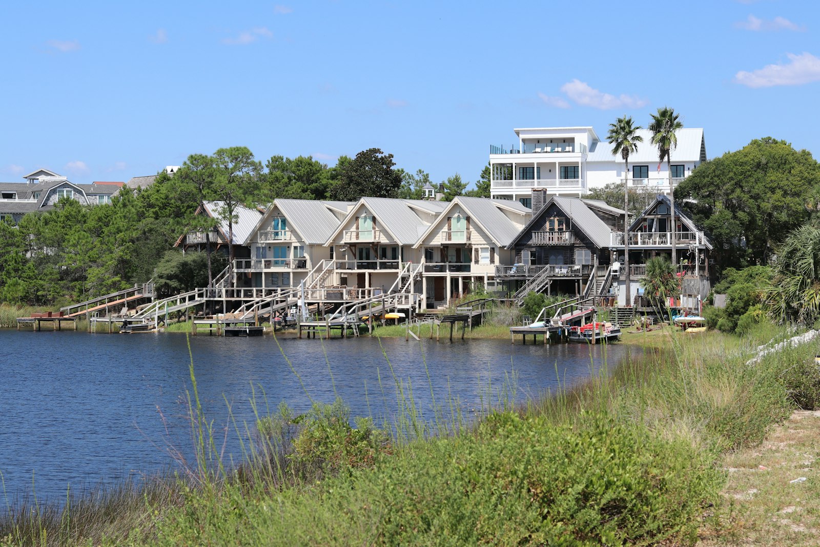 Waterfront houses with wooden docks and boats.