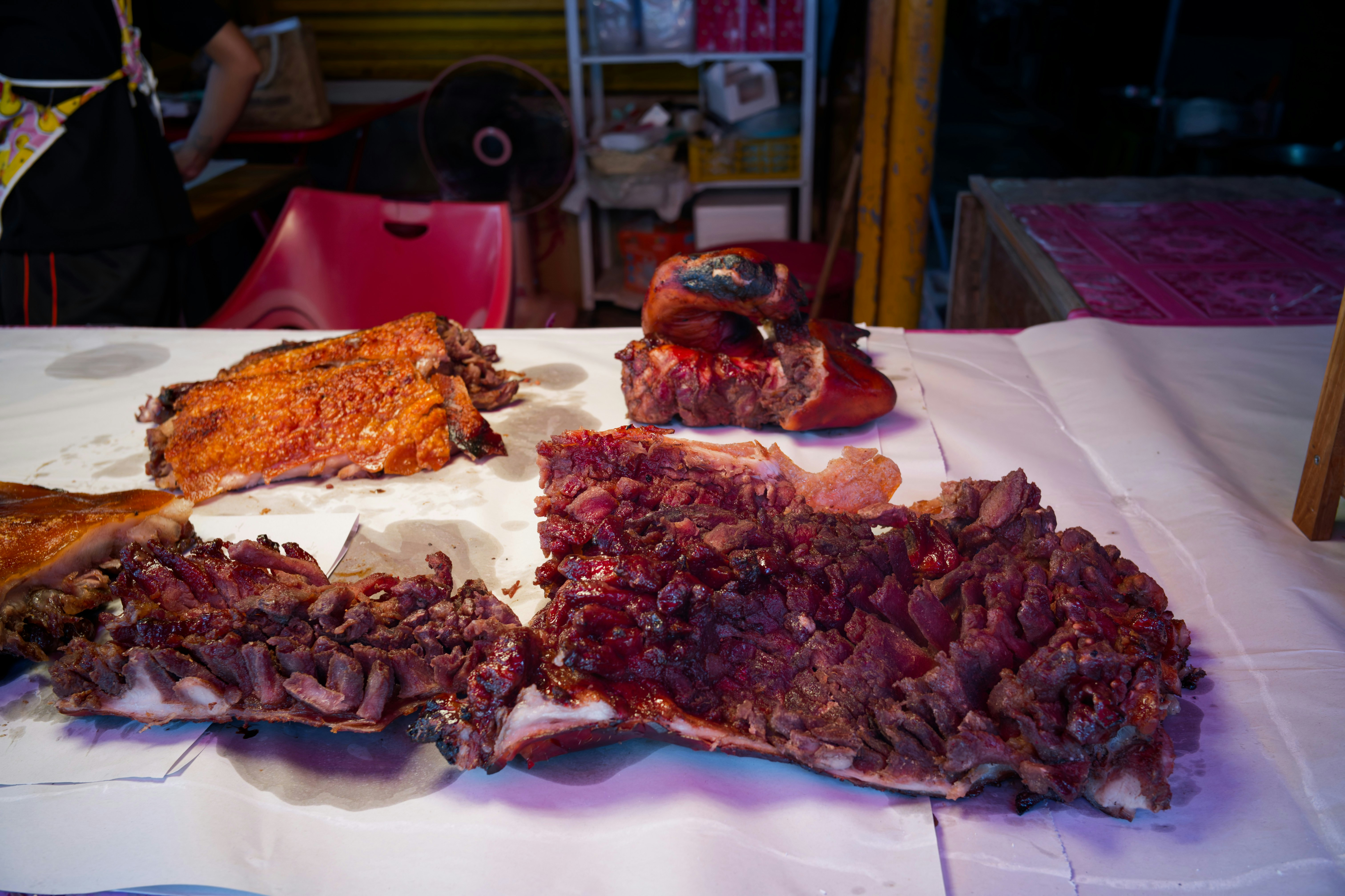 Several large cuts of roasted meat on a table.