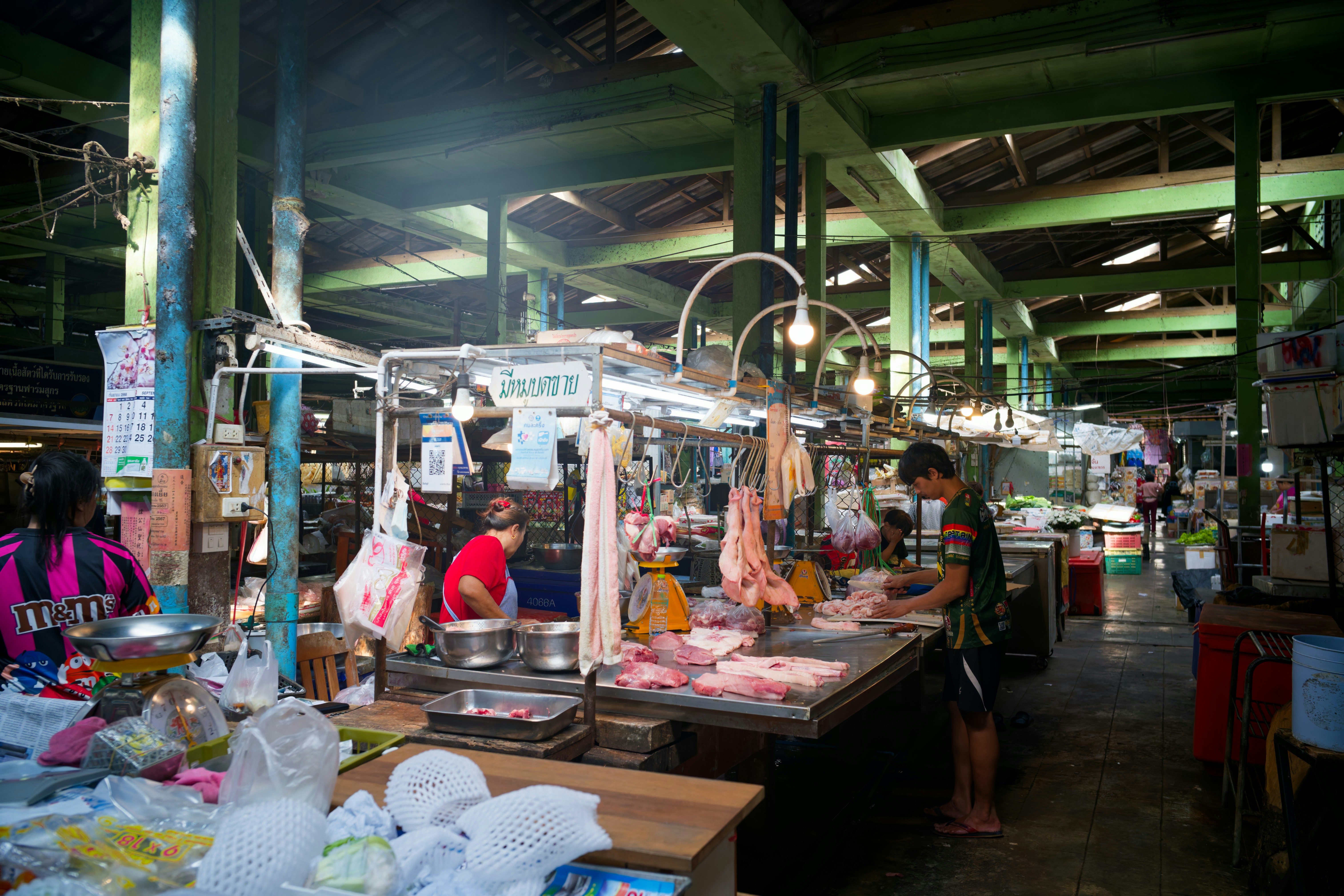 Butcher stalls at a bustling indoor market