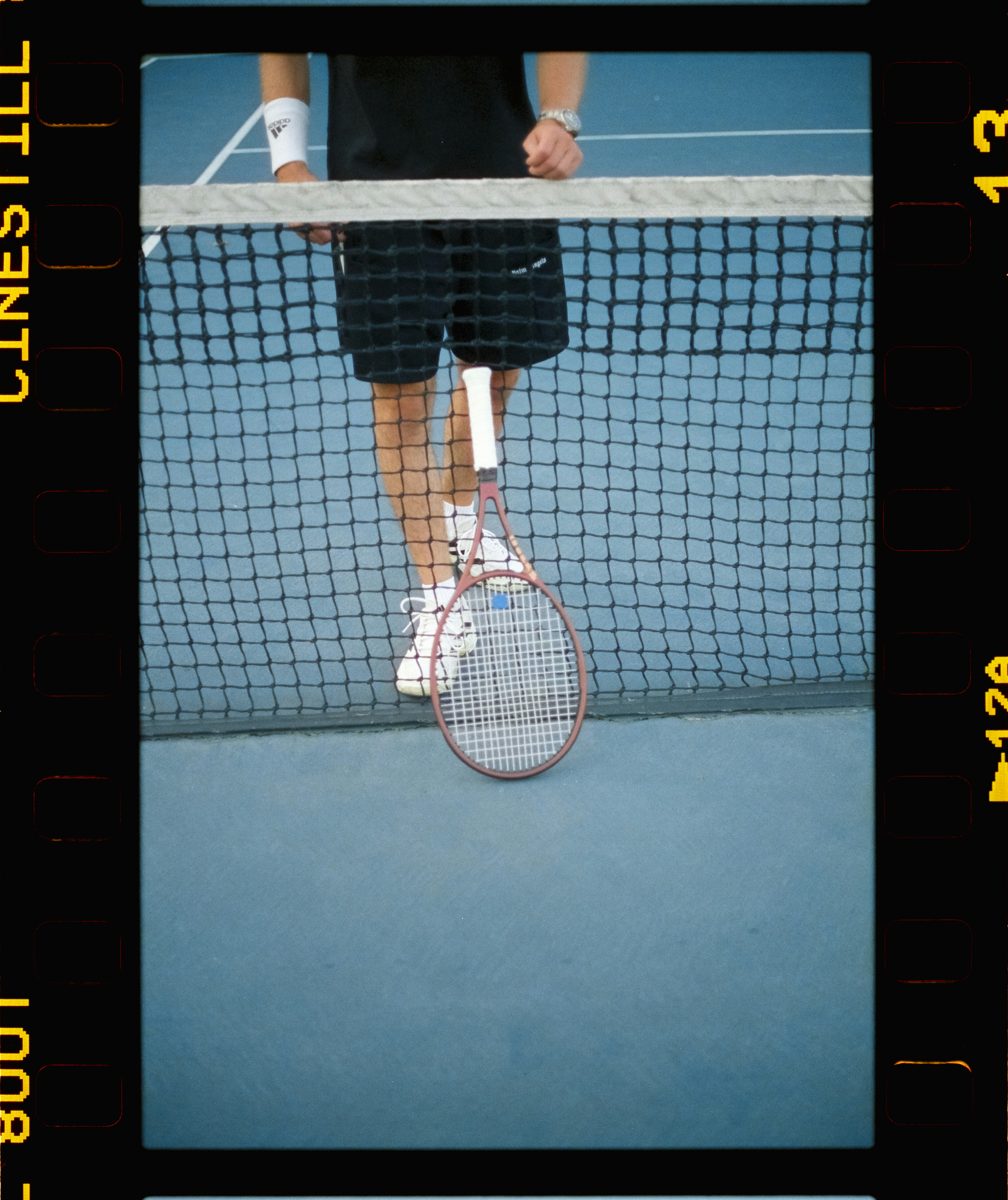 Tennis player with racket on blue court