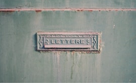 Metal mailbox slot with the word lettere