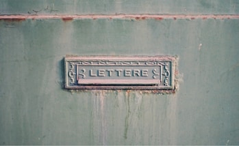 Metal mailbox slot with the word lettere
