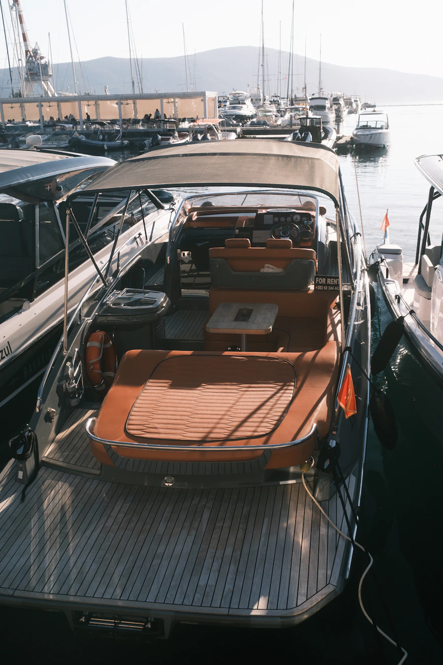 Luxury yacht illuminated at sunset in marina