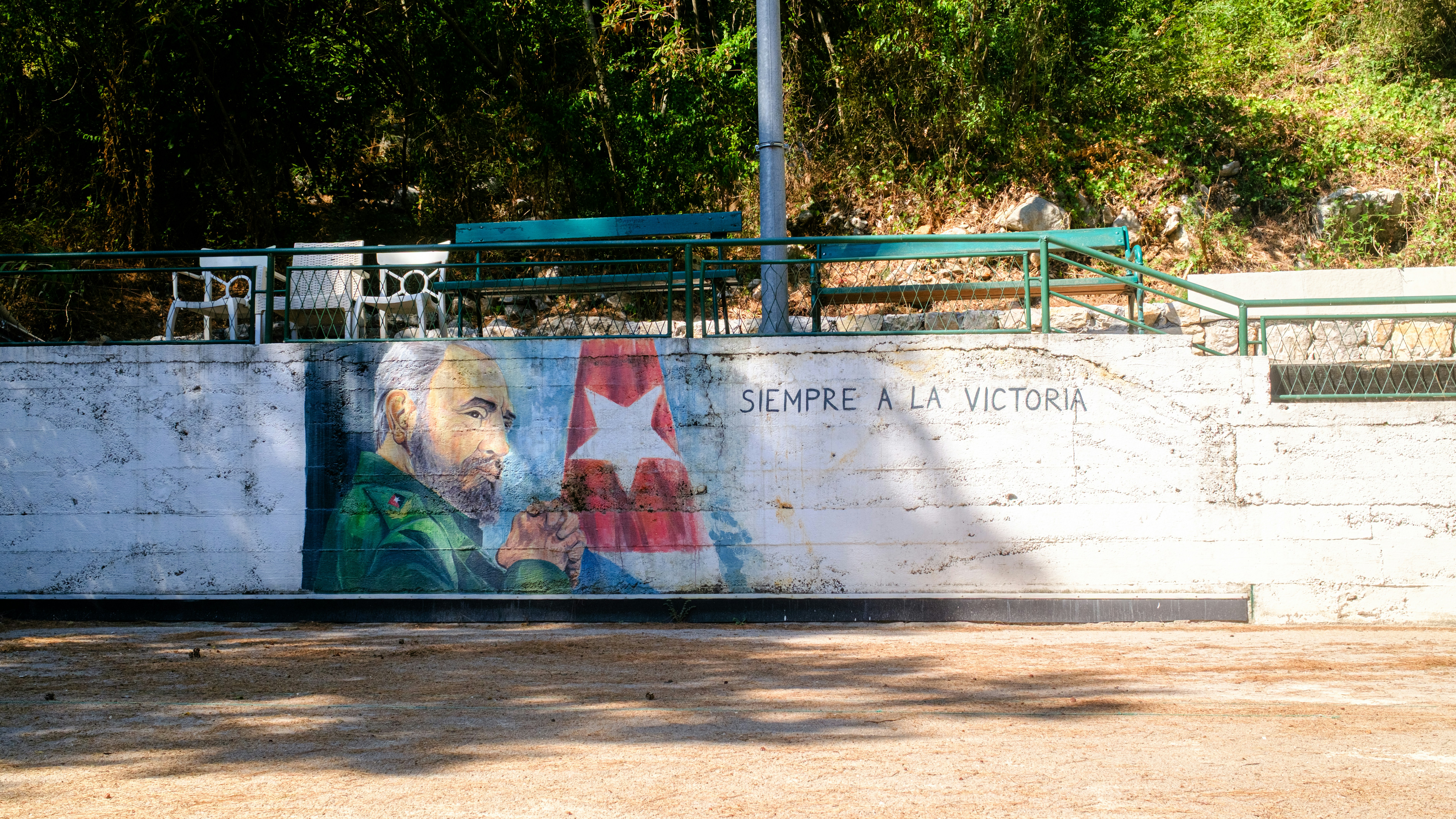 Mural of fidel castro and cuban flag on wall