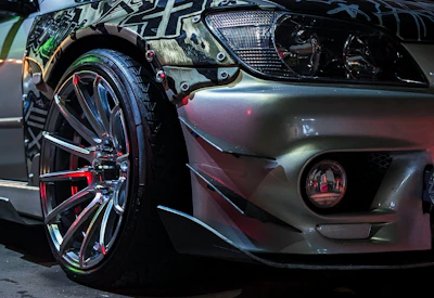 Close-up of a custom sports car with chrome wheels.