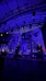 Stage with guitars and drum set under blue lights