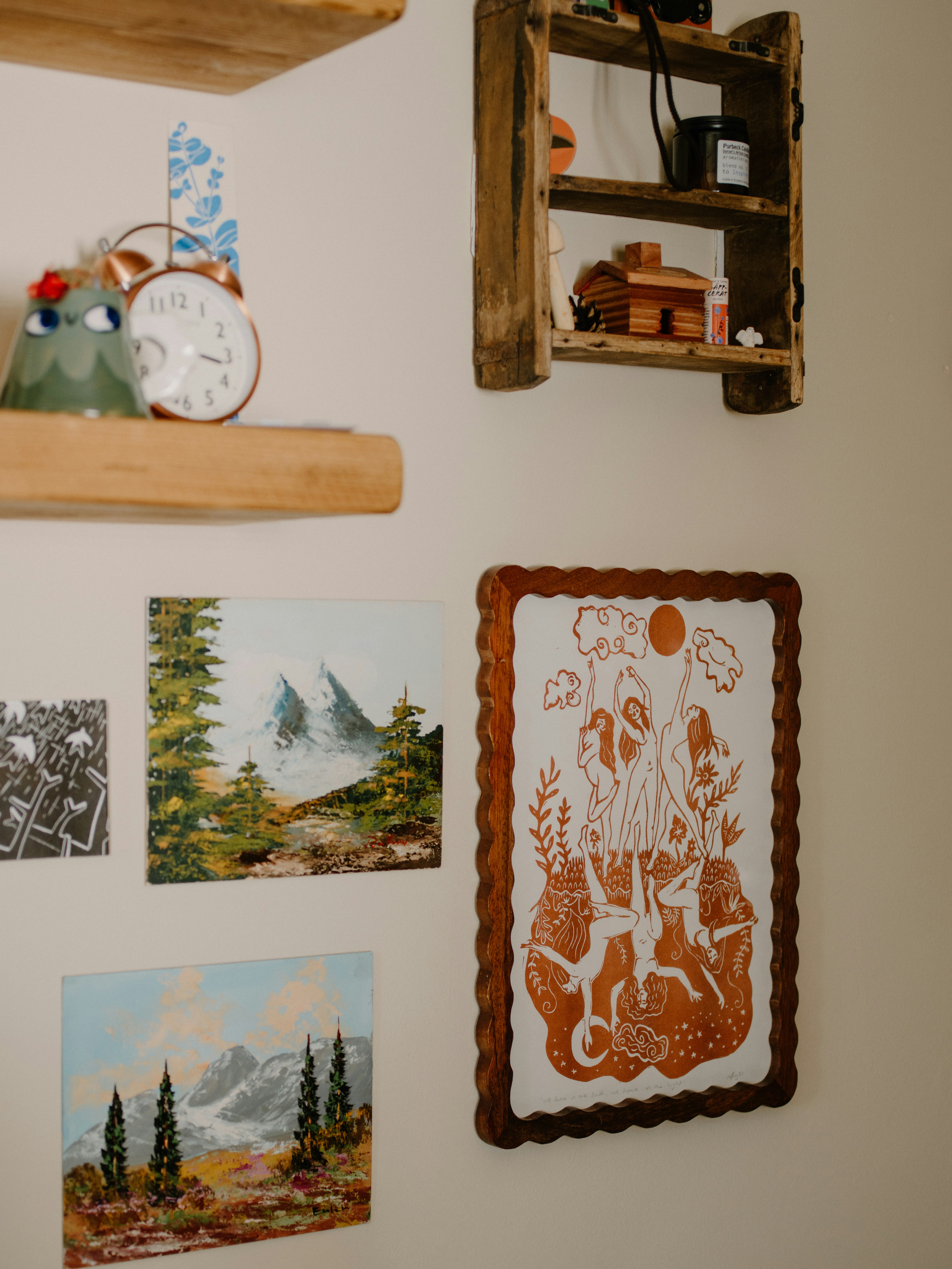 Wall art including paintings and a framed illustration.