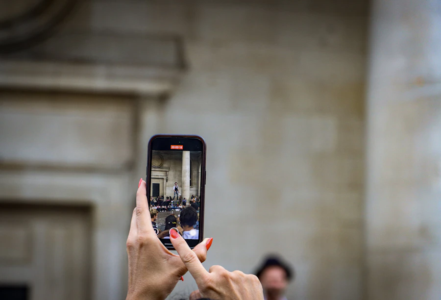 Filming a runway show on a phone — a fan capturing what they love