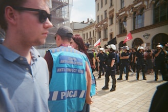 Police officers in riot gear stand in formation.