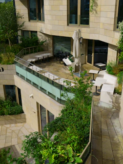 Modern building with an outdoor patio and greenery