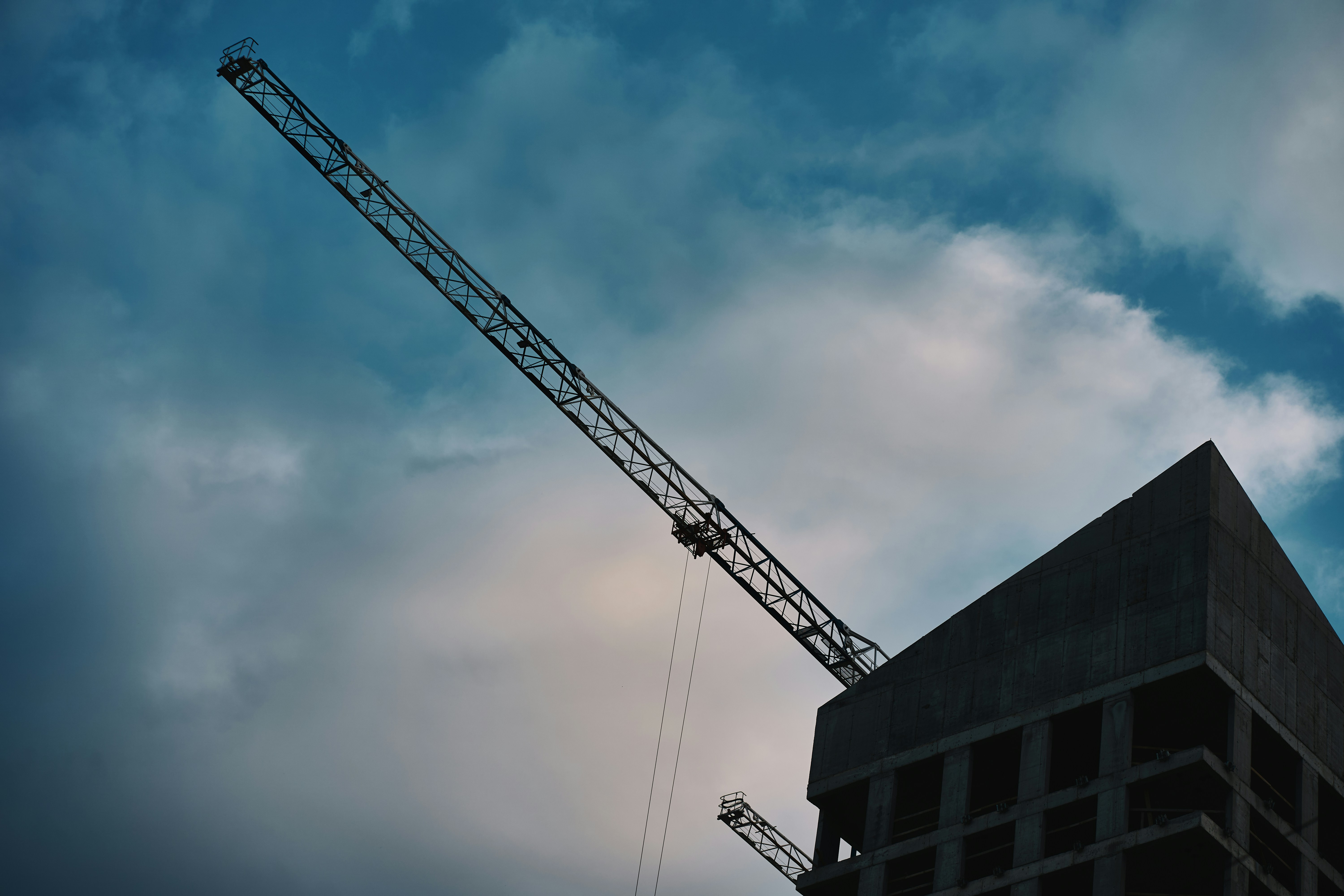 Construction crane against a cloudy sky