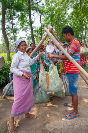 Workers weighing harvested tea leaves at a farm.