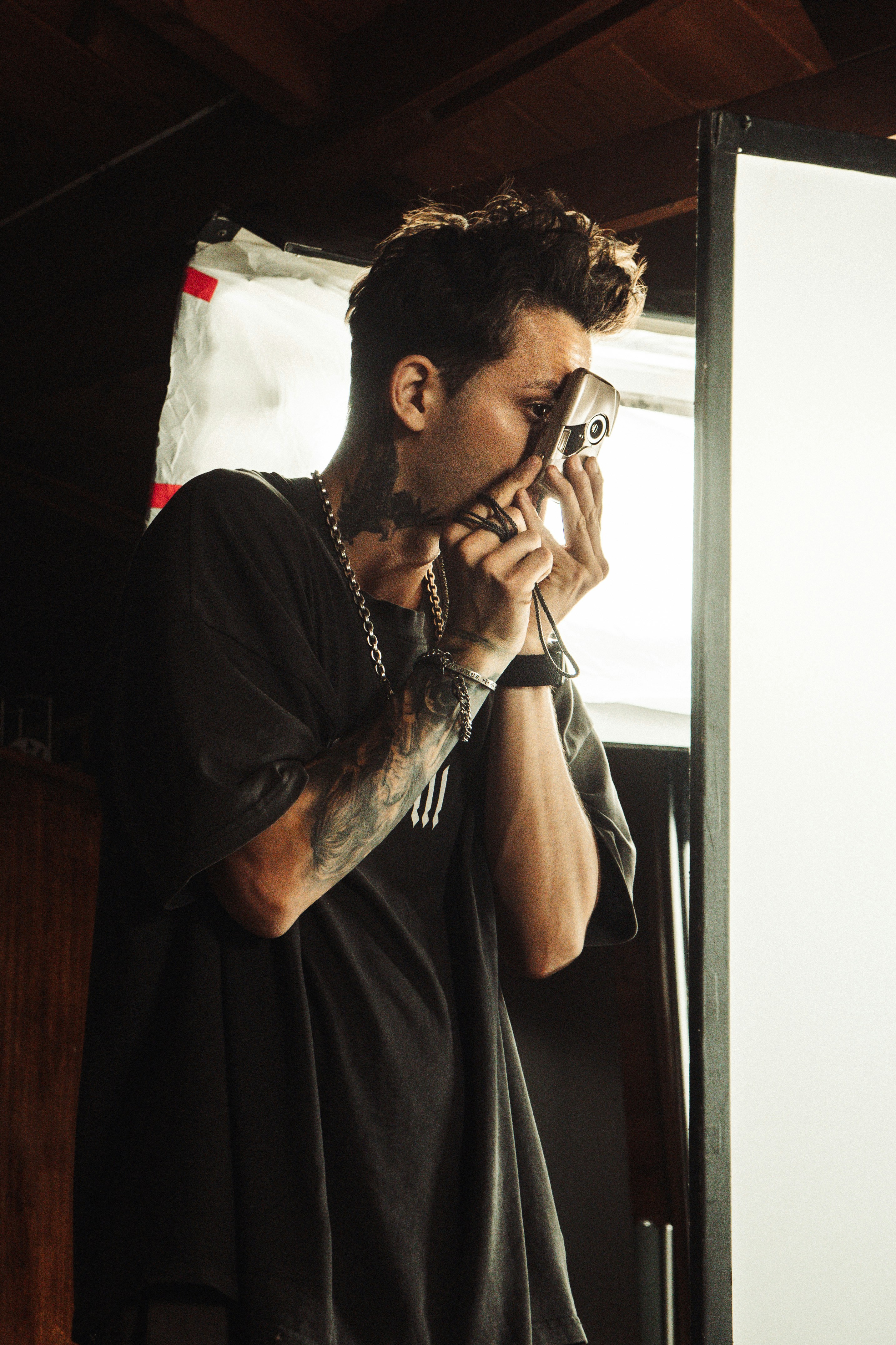 Man holding vintage camera to his eye