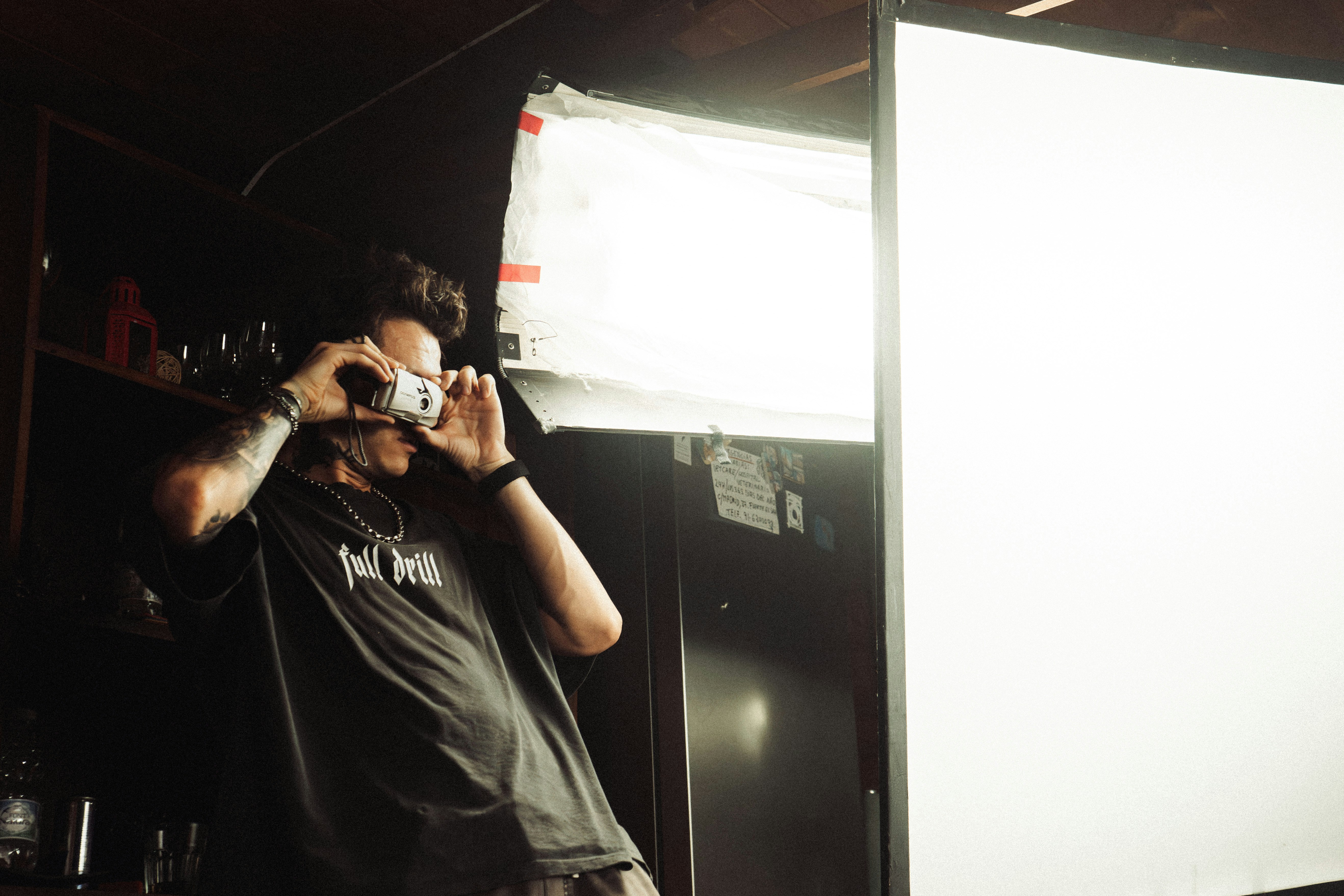 Man holding camera in front of bright light