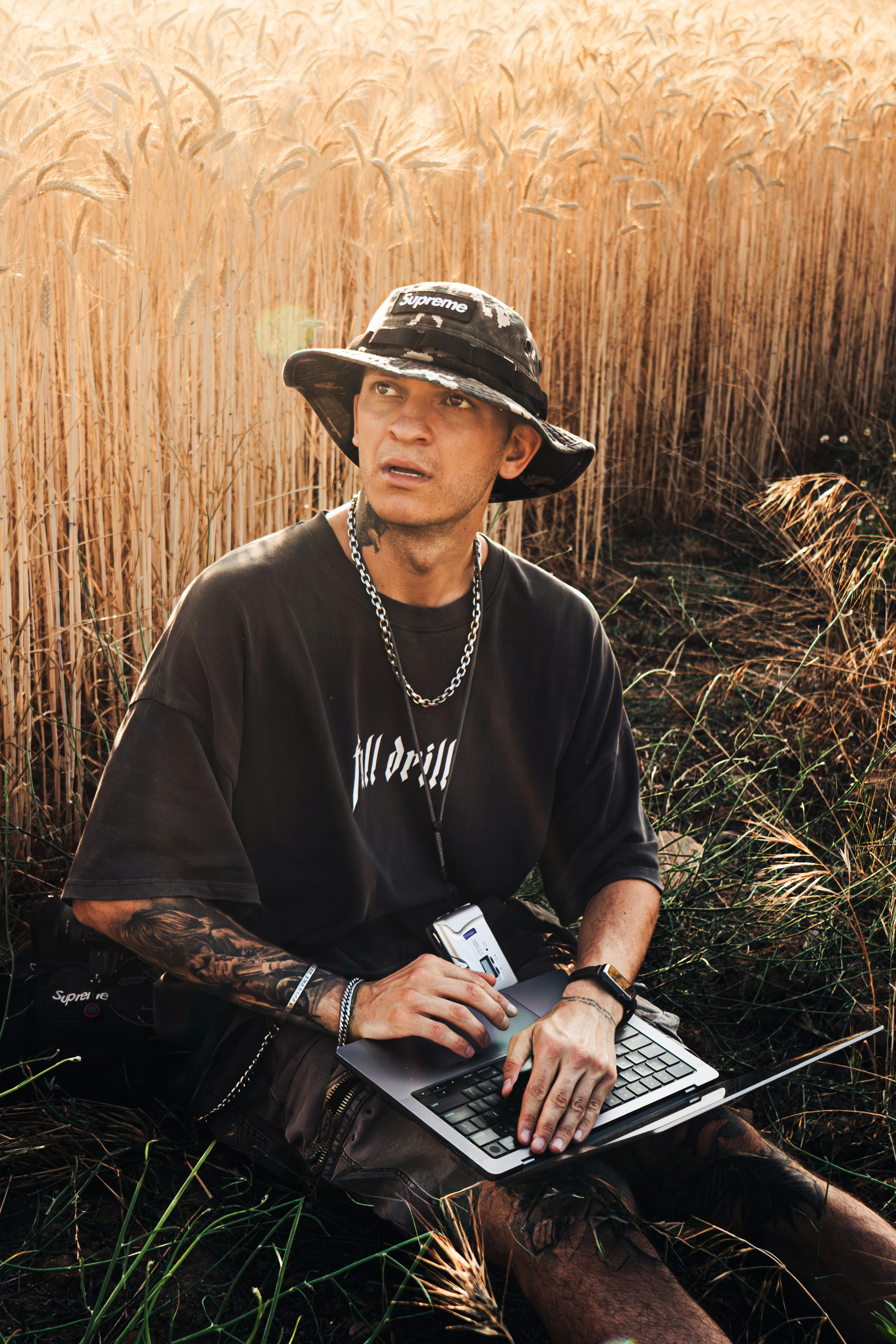 Man with laptop in a wheat field