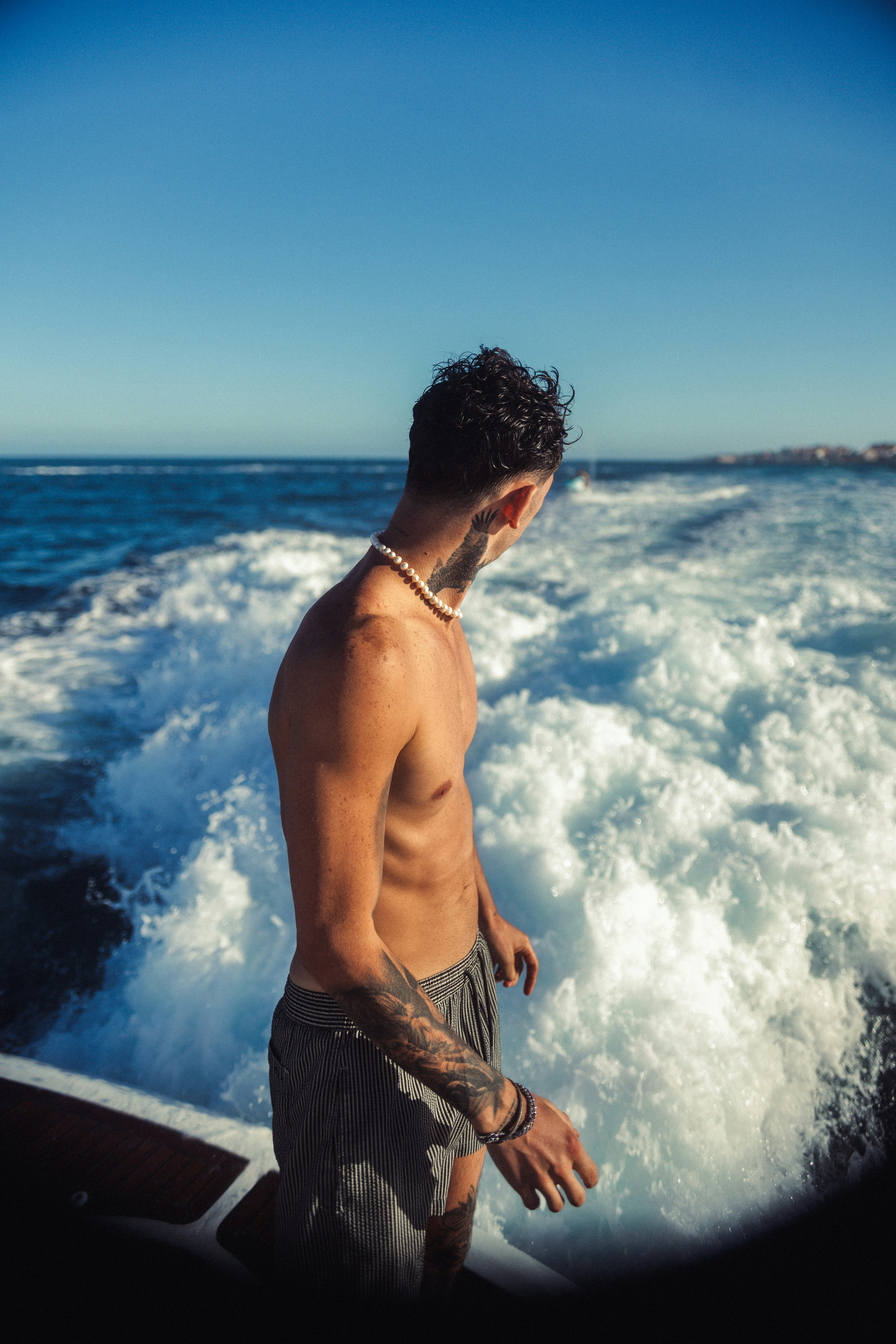 Man on a boat looking at ocean waves