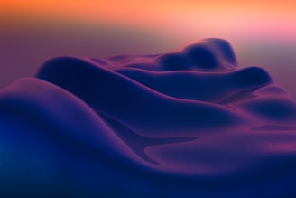 Abstract flowing purple and blue shapes with orange sky
