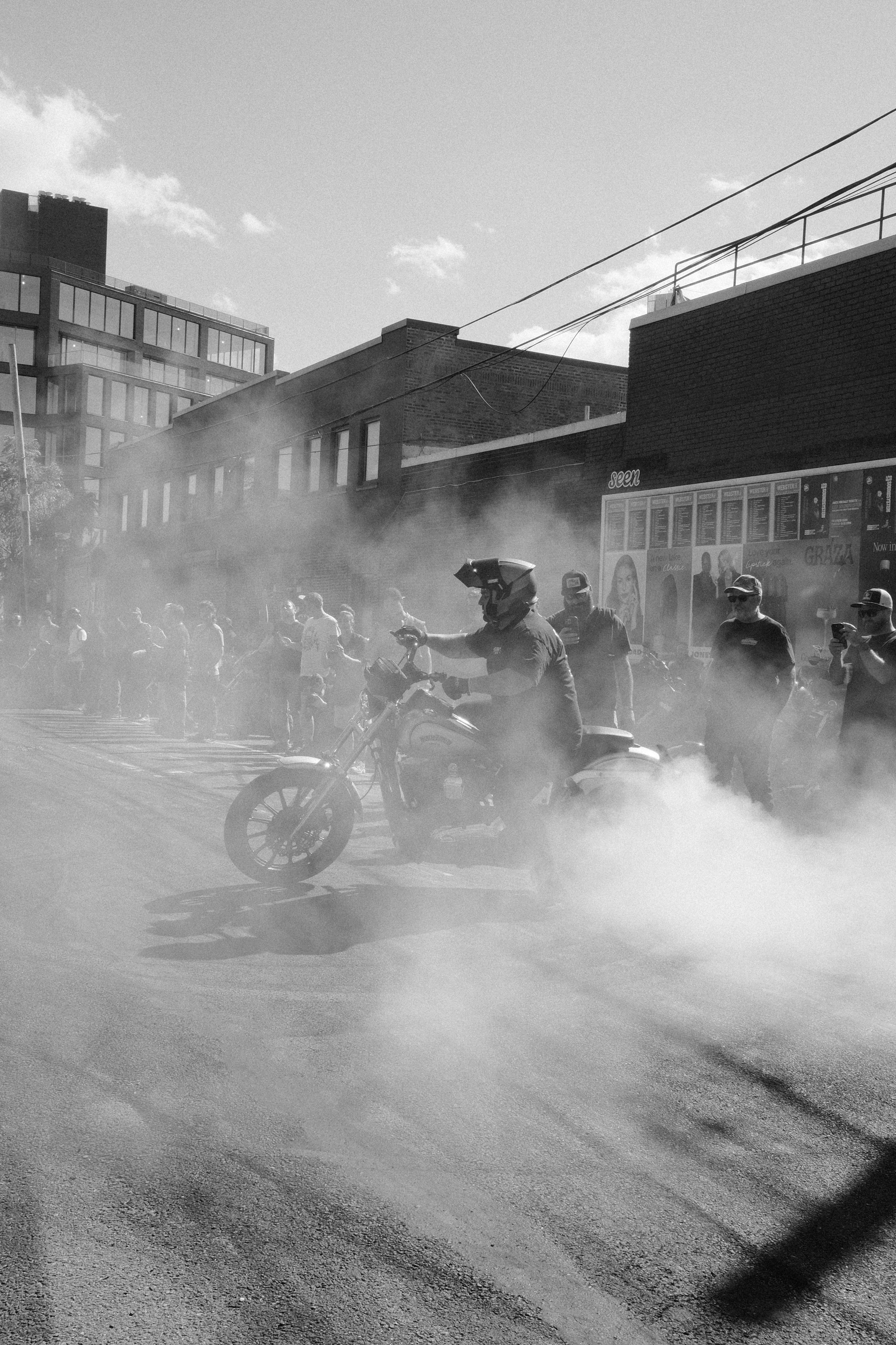 Motorcyclist doing a burnout in a smoky street