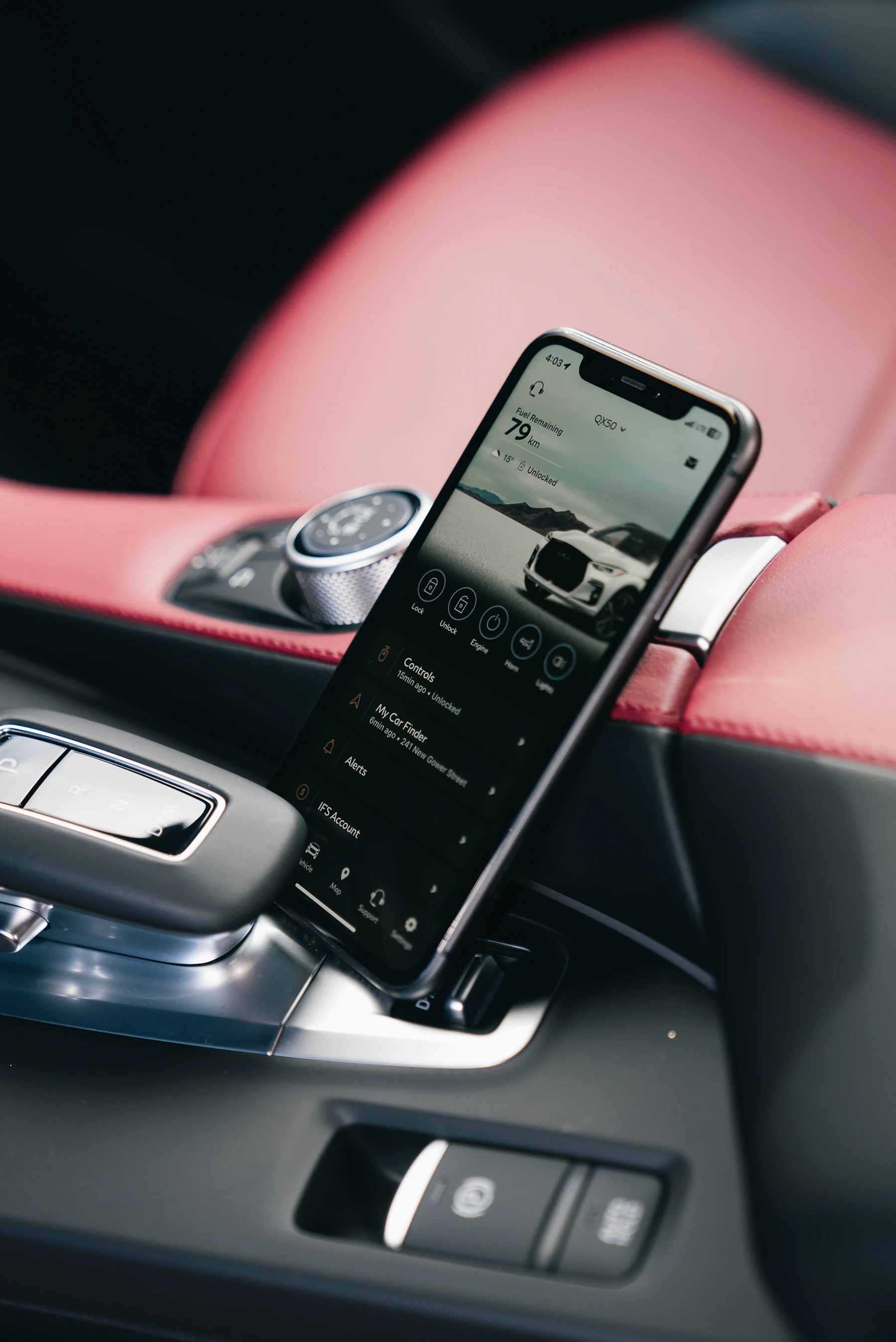 Smartphone positioned inside a modern vehicle center console