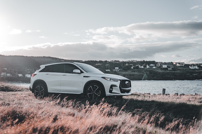 white luxury SUV parked by waterfront property