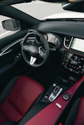 Luxury car interior with red leather seats.