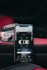 Smartphone displaying car diagnostics app on dashboard