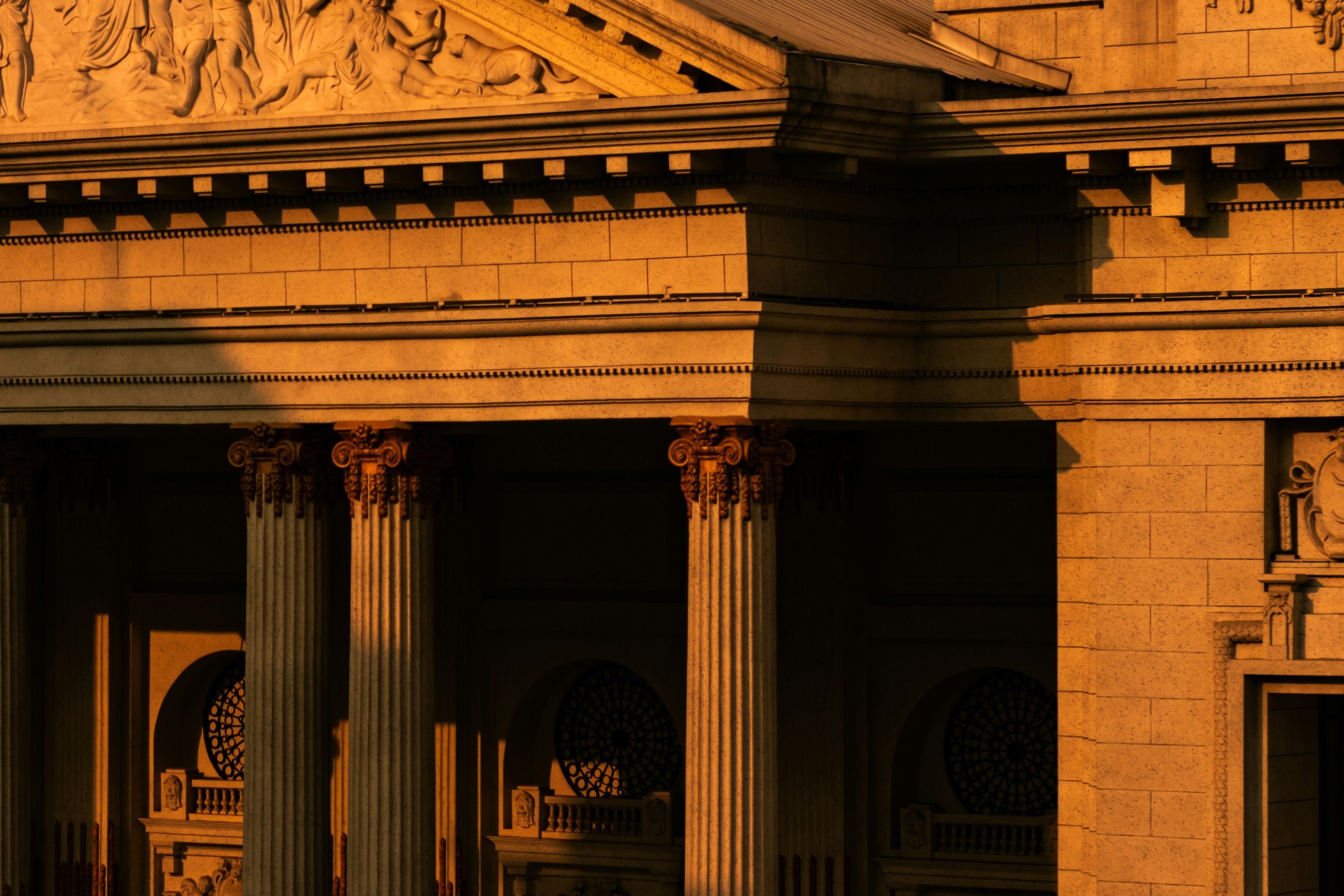 Golden hour illuminates classical architecture with columns