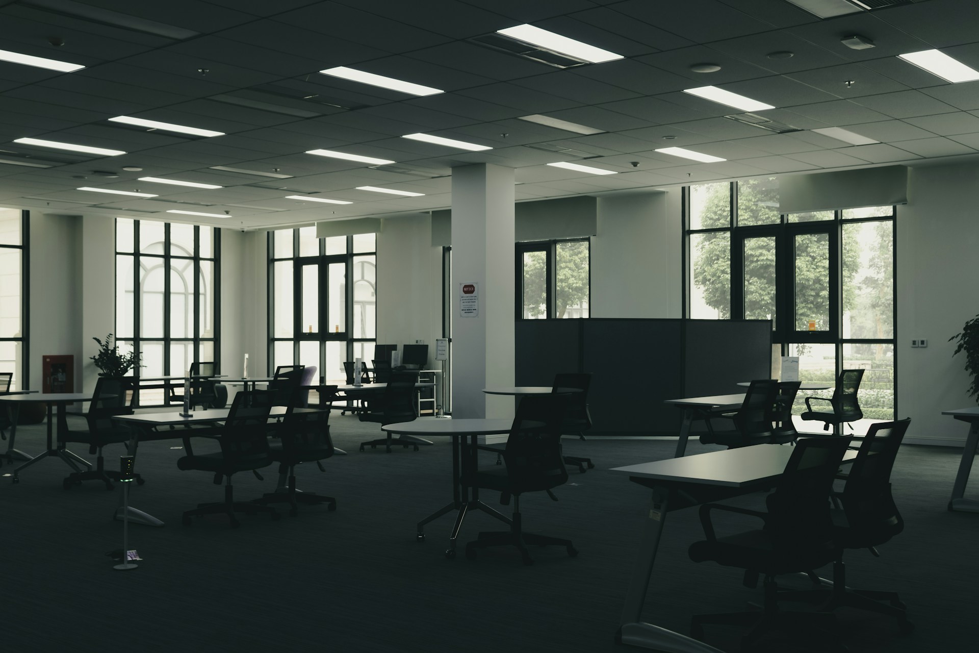 Empty modern office space with tables and chairs.